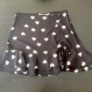 Black mini skirt with white hearts, size small, brand “mi ami”, worn once
